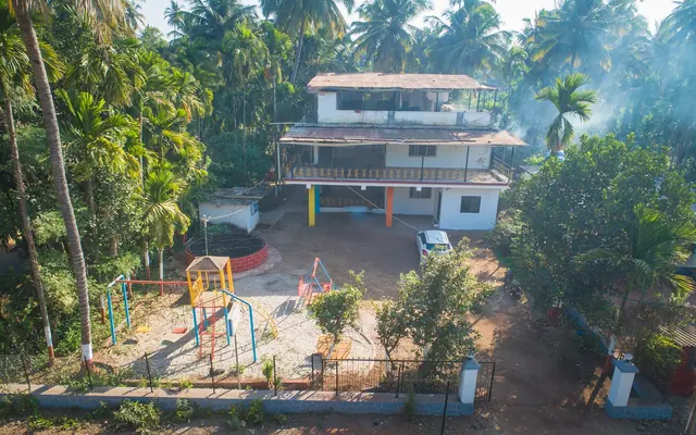 Airawat Resort from above, among coconut palms, with the play area in front
