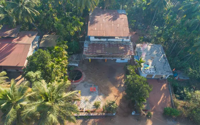 Aerial view of Airawat Resort and its tiled roofs in the trees