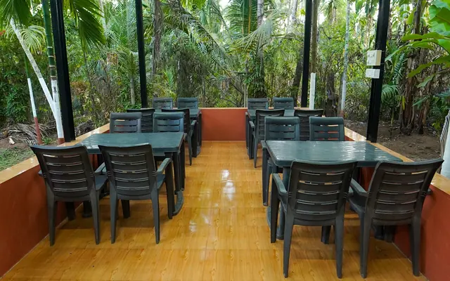 Dining area at Airawat with palms behind