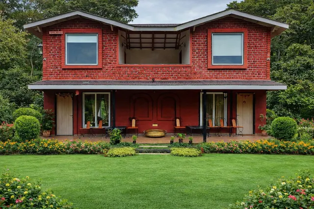 The Little Red Cottage, a two-storey red brick house with a front lawn