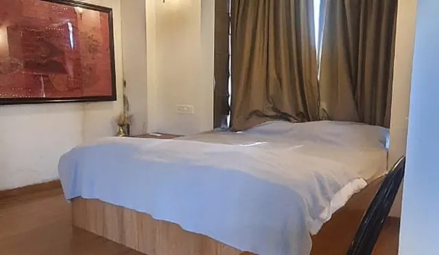Bedroom at the Little Red Cottage with a large bed