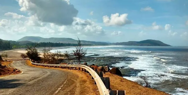 A coastal road curving along the sea