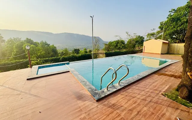 Redroof Farmhouse pool looking out over the hills of Paud